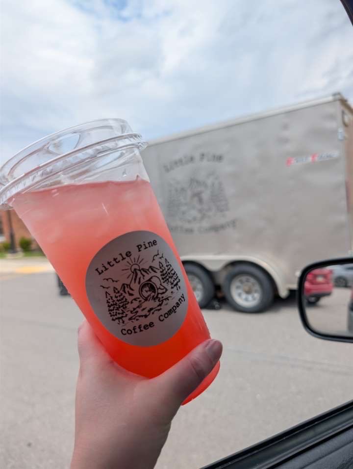 Pink iced beverage from Little Pine Coffee Company in a branded plastic cup