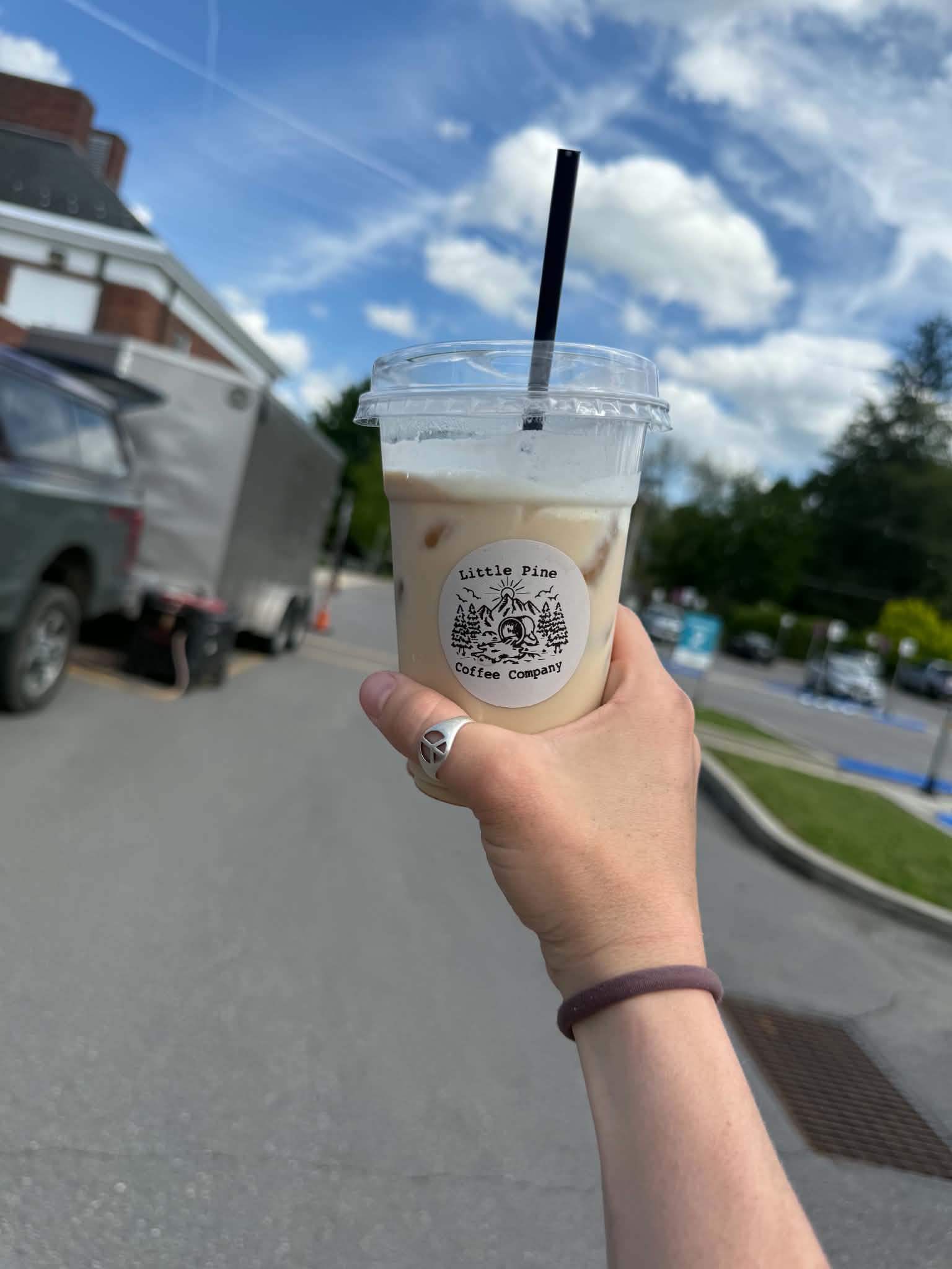 Iced coffee from Little Pine Coffee Company held outside on a sunny day